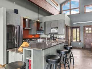 This stunning kitchen boasts modern design and high-end appliances, perfect for culinary enthusiasts.