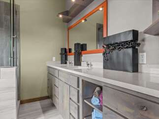 This stunning bathroom features a modern design with a double vanity and ample storage.