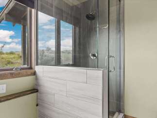Step into a luxurious bathroom retreat featuring a stunning glass-enclosed shower.