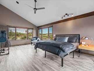 Experience luxury in this stunning bedroom featuring a modern design and ample natural light.