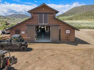 Discover the charm of this stunning property featuring a spacious barn with ample storage and a workshop area.