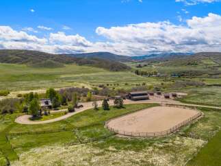 Discover your dream ranch property! This stunning estate boasts a spacious riding arena, perfect for equestrian enthusiasts.