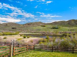 Discover the tranquility of this stunning property, offering breathtaking views of a serene lake and rolling hills.