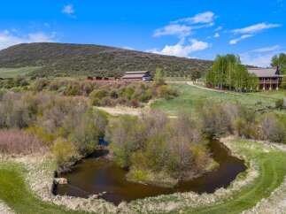 Discover your dream property in this stunning rural setting! This expansive estate features a beautiful home, a barn, and lush green surroundings.