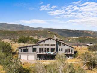 Discover this stunning modern home nestled in a picturesque landscape, offering breathtaking mountain views.