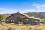 Nestled amidst rolling hills, this stunning property offers a unique architectural design with expansive windows that capture breathtaking natural light and scenic views.