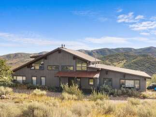 Nestled amidst rolling hills, this stunning property offers a unique architectural design with expansive windows that capture breathtaking natural light and scenic views.