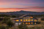 Experience breathtaking mountain views from this stunning contemporary home, perfectly situated to capture the vibrant sunset hues.