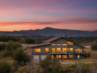 Experience breathtaking mountain views from this stunning contemporary home, perfectly situated to capture the vibrant sunset hues.