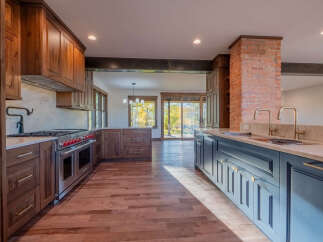 This stunning kitchen boasts custom cabinetry, a high-end range, and a spacious layout perfect for entertaining.