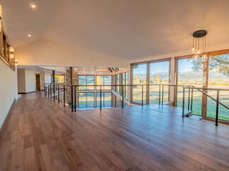 Experience luxury living in this stunning property featuring a spacious interior with hardwood floors and expansive windows.
