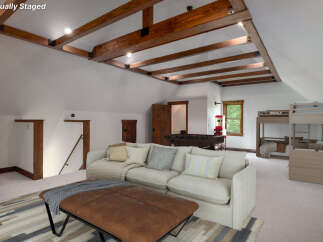 This stunning property boasts a spacious living area with a cozy sectional sofa, perfect for relaxation.