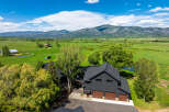 Experience luxury mountain living in this stunning modern farmhouse estate, nestled amidst sprawling green fields and majestic mountain vistas.
