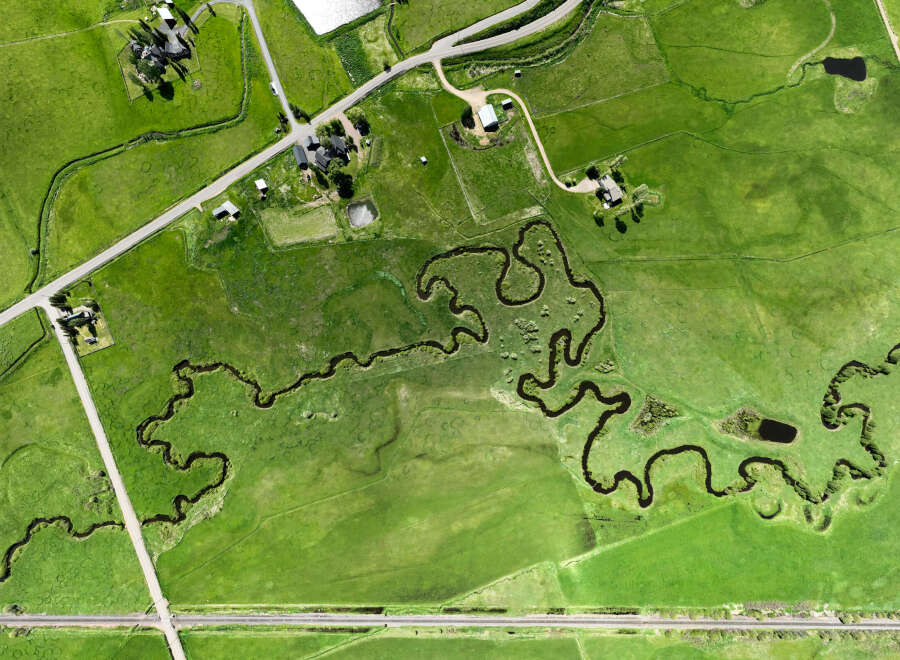 Discover this stunning aerial view of a sprawling green landscape, perfect for agricultural or recreational use.