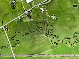 Discover this stunning aerial view of a sprawling green landscape, perfect for agricultural or recreational use.