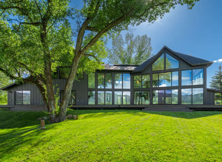 Experience modern luxury in this stunning home featuring expansive floor-to-ceiling windows that flood the interior with natural light and offer breathtaking views of the surrounding landscape.