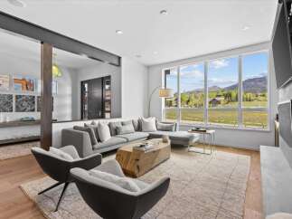 Experience luxury living in this stunning property, featuring a spacious living room with breathtaking views.