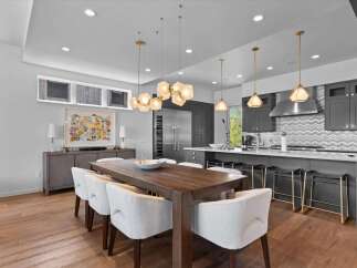 This stunning modern kitchen and dining area boasts a seamless blend of style and functionality.