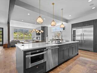 This stunning kitchen boasts modern design and high-end appliances, perfect for culinary enthusiasts.