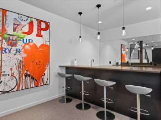 This stunning property features a modern bar area, perfect for entertaining guests.