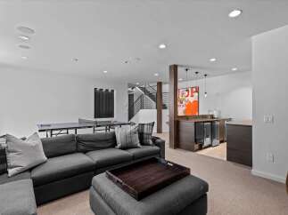This stunning property boasts a modern interior with a spacious living area, perfect for entertaining.