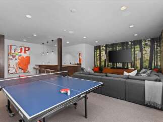 This stunning property boasts a modern entertainment space, perfect for hosting gatherings or enjoying quiet evenings.