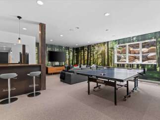 This stunning property boasts a modern entertainment space, perfect for hosting gatherings.