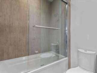 Step into a beautifully designed bathroom featuring a modern glass shower enclosure.