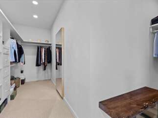 Step into luxury with this stunning walk-in closet, designed for both style and functionality.