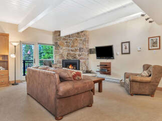 Step into luxury with this stunning living room featuring a cozy stone fireplace, perfect for those chilly evenings.