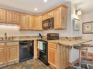 This stunning kitchen boasts beautiful wooden cabinetry, offering ample storage and a warm, inviting atmosphere.