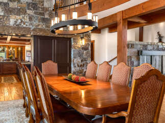 Step into luxury with this stunning dining room, featuring a grand wooden table perfect for hosting gatherings.