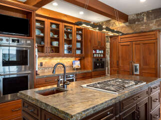This stunning kitchen boasts custom cabinetry, a gourmet gas cooktop, and a large island perfect for entertaining.