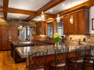 This stunning kitchen showcases custom cabinetry, granite countertops, and a spacious island perfect for entertaining.