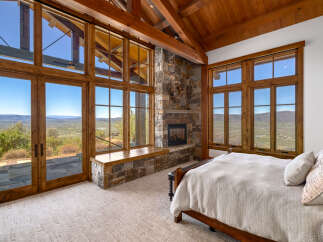 Experience luxury living in this stunning bedroom with breathtaking views.