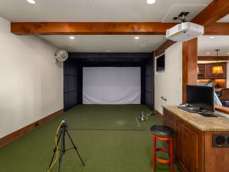 Step into luxury with this state-of-the-art golf simulator room, perfect for honing your skills or enjoying a friendly game.