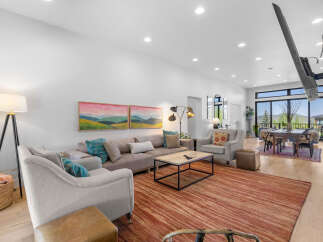 Step into luxury with this stunning living room, featuring a spacious sectional sofa and elegant armchairs.