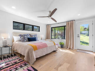 This stunning bedroom boasts a bright and airy atmosphere, perfect for relaxation.