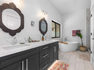 This stunning bathroom boasts a modern design with a luxurious soaking tub, perfect for unwinding after a long day.