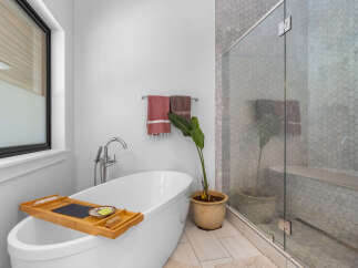 This luxurious bathroom features a modern design with a freestanding bathtub, perfect for relaxation.