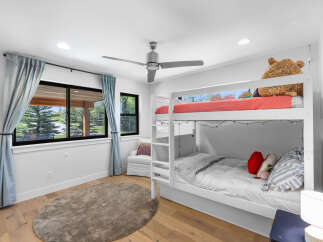 This charming bedroom features a cozy bunk bed, perfect for kids or guests.
