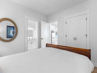Step into this bright and airy bedroom, featuring a comfortable bed and ample natural light.