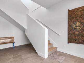 This stunning property boasts a modern interior with a unique staircase design.