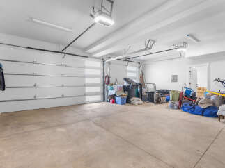 This spacious garage offers ample storage space and a clean, well-lit environment.