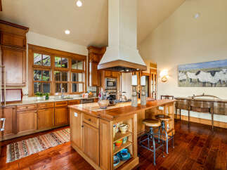 This stunning kitchen boasts custom cabinetry, a large island with seating, and high-end appliances.