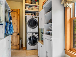 This stunning property boasts a well-designed laundry room, complete with a modern washer and dryer set.