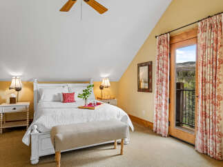 This charming bedroom offers a cozy retreat with its inviting ambiance and elegant design.