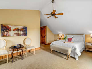 This charming bedroom offers a cozy retreat with its inviting ambiance and stylish decor.