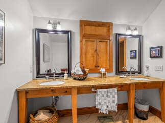This stunning bathroom features a custom vanity with dual sinks, offering ample space and functionality.
