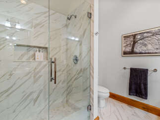 Step into luxury with this stunning bathroom featuring a modern glass shower enclosure.